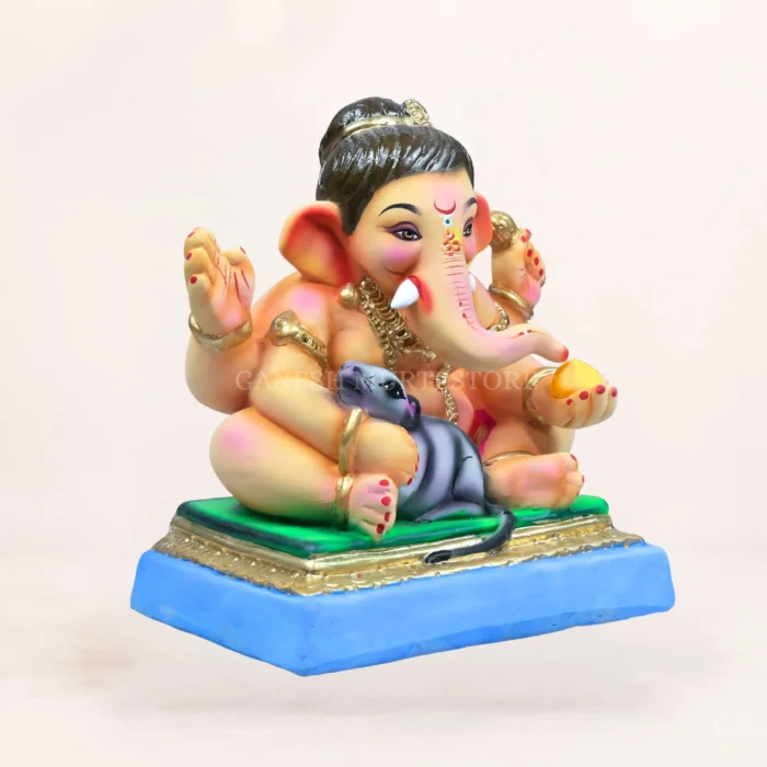 Close up detailed view of 12 inch Baal Ganesh eco-friendly clay idol with Mushak in pink dhooti