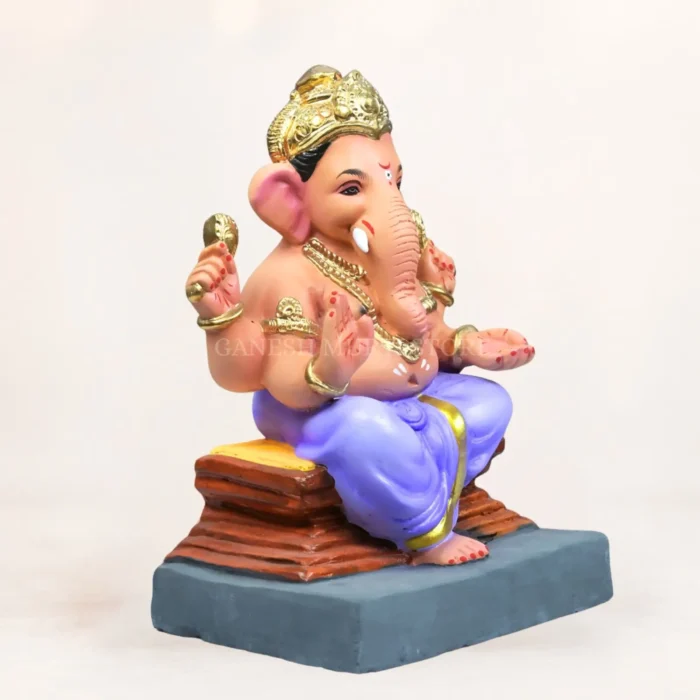 Angled front view of 12 inch Ambuja light yellow KP eco-friendly clay Ganesh idol for home temple