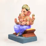 Close up front view of 12 inch Ambuja light yellow KP eco-friendly clay Ganesh idol facial details
