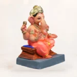 Side view of 12 inch Chaurang Orange KP eco-friendly clay Ganesh idol seated on throne for Ganesh Chaturthi home pooja