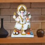 Front view of Seated Ganesh Marble Dust Idol in pink dhoti with golden halo