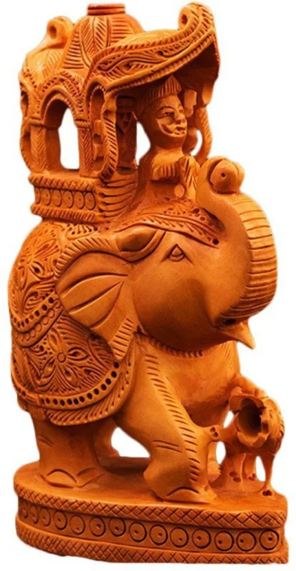 Side-angle view of handcrafted wooden Ambabari elephant statue highlighting royal howdah and fine wood grain details