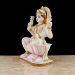 Side angle view of Hindu Goddess Lakshmi Idol seated on lotus with intricate golden embellishments