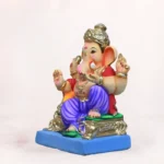 Side profile of 14 inch eco friendly Shadu Mati Ganpati murti with royal blue dhoti and parbhal load
