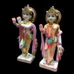 Close up detail of handcrafted Bal Roop Lord Krishna idol with cow featuring hand painted ornament details