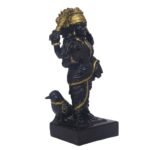 Side view of Black Marble Dust Shanidev Idol highlighting golden weapon and side profile