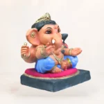 Side profile view of 14 inch eco friendly Shadu Mati Undir Gattu Ganpati murti with light blue dhoti
