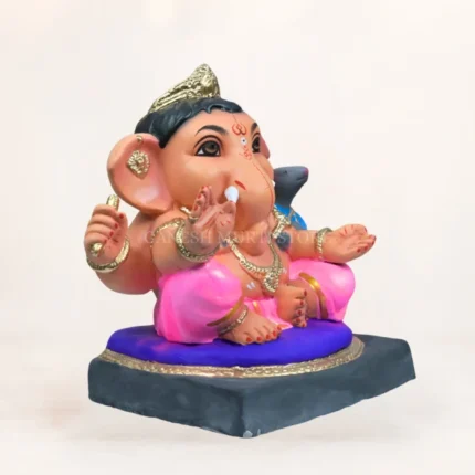 Side profile of 14 inch eco friendly Shadu Mati Undir Gattu Ganpati murti in pink dhoti