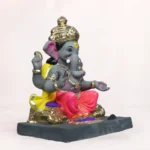 Side profile view of 14 inch eco friendly Shadu Mati Vithu Singhaasan Ganpati murti in pink dhoti