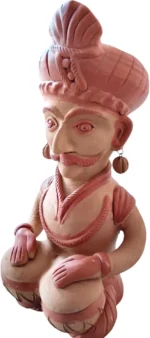 Side angle view of handcrafted Indian terracotta musician figurine highlighting intricate folk art details